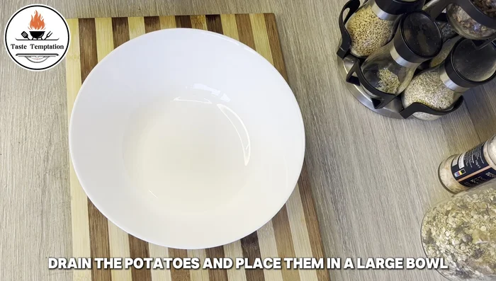 Drain potatoes and mash them in a bowl.