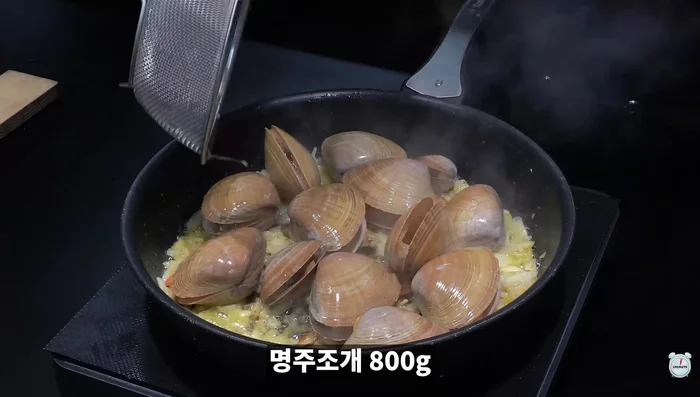 Add clams, white wine, and salt. Cover and boil for 5 minutes.