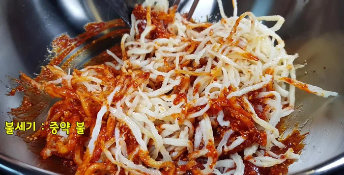 Add the squid kimchi and stir-fry until well combined.