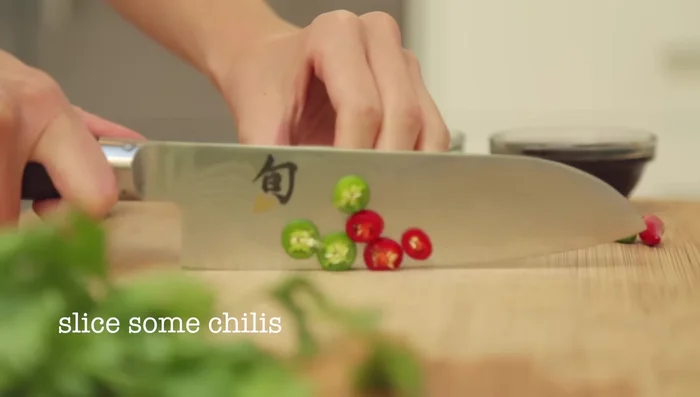 Slice sano chilies and ginger for the sauce.