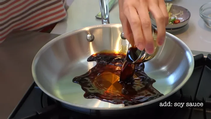 In a shallow pan, simmer soy sauce, water, and cane sugar until dissolved. Add ginger and chilies; simmer for 1 minute.
