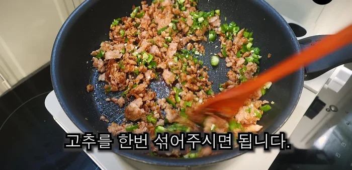 Add the chopped peppers to the pan and mix with the remaining heat to preserve flavor and crunch.