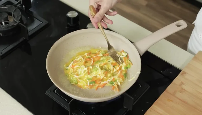 Pour the egg mixture into the pan and spread evenly.