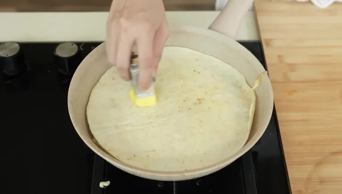Let the egg cook until set, then flip the tortilla and egg.