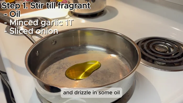 Heat a skillet over medium-high heat and add oil. Add minced garlic and sliced onion; stir until fragrant.
