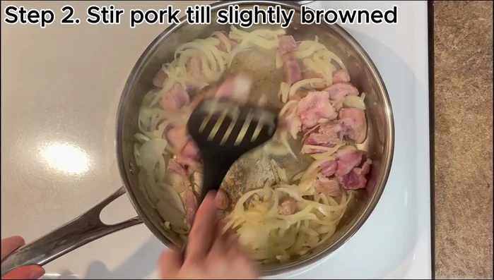 Add the pork (if using) and stir until it starts to change color. Add 1 tablespoon of soy sauce and stir.