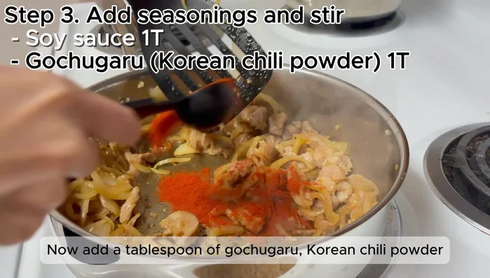 Add 1 tablespoon of gochugaru (Korean chili powder) and stir briefly. Push everything to the side.