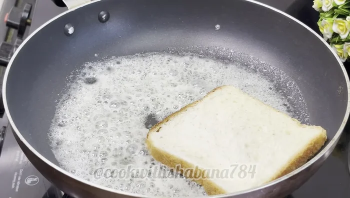 Toast the bread slices in a buttered pan over low heat until lightly golden brown on both sides (122.64).
