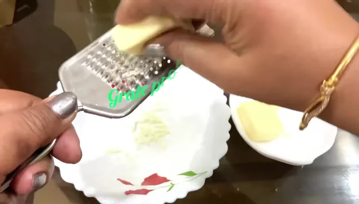 Grate 2 process cheeses.