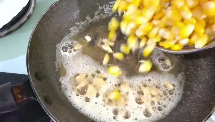Add the cooked corn to the pan.