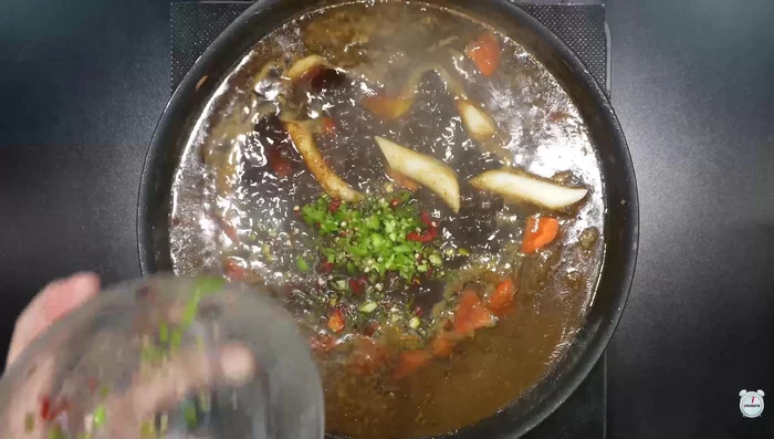 Add potatoes, carrots, rice cakes, and green chili peppers to the broth and simmer.