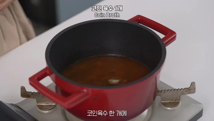 Pour in water, add a coin of soybean paste, and stir well until dissolved.