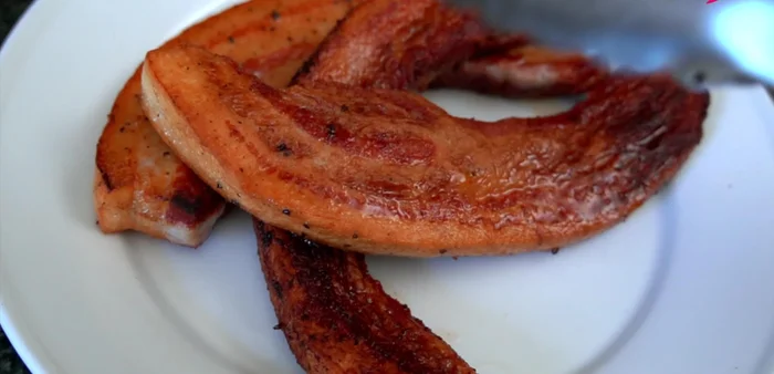 Remove and drain: Remove pork belly from the pan and let it rest on a plate for a minute. Pour rendered fat into a bowl (or discard). (280.759)