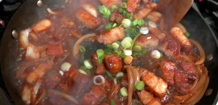 Garnish and serve: Stir in scallions. Serve over rice. Garnish with sesame seeds and chili threads (optional). (436.879)