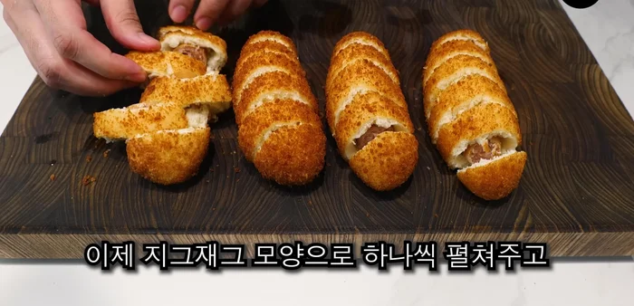 Spread the hot dogs in a zigzag shape and press down to create a flat, fallen leaf shape.