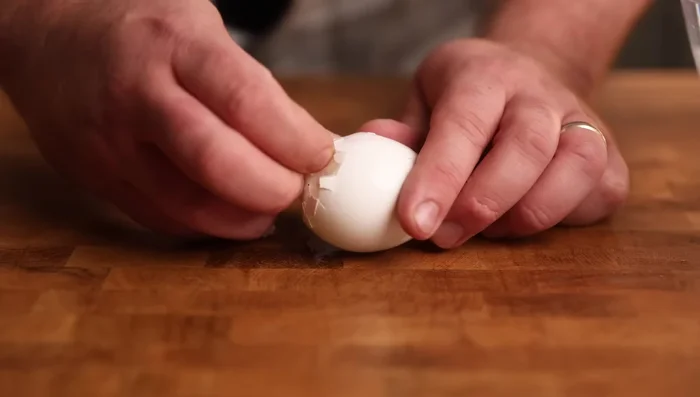 Refresh eggs in iced water, tap and peel carefully.