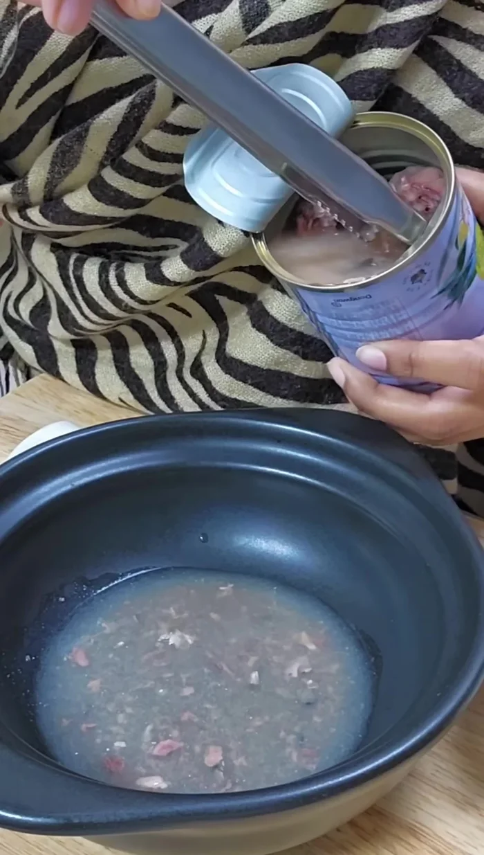 Open the canned fish and drain excess liquid.