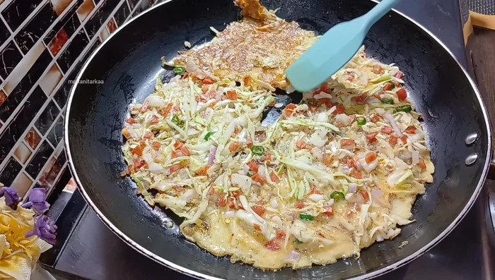 Flip the omelette and cook the other side for about 1-1.5 minutes until lightly browned.
