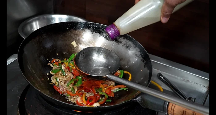 Add chilli paste, vinegar, tomato ketchup, green chilli sauce, soy sauce, oyster sauce, salt, Ajinomoto, black pepper, and Chinese masala. Mix well.