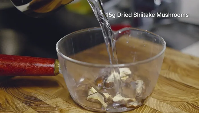 Soak dried shiitake mushrooms in cold water to rehydrate.