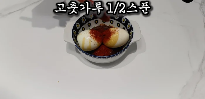 Prepare the egg seasoning: In a bowl, mash two soft-boiled or half-boiled eggs. Add 1.5 spoons of soy sauce, 0.5 spoons of sugar, and 0.5 spoons of red pepper powder. Mix well.