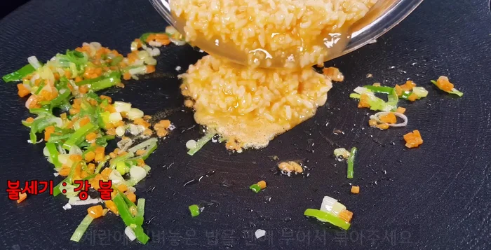 Push the stir-fried vegetables to the sides of the pan. Add the egg and rice mixture to the center of the pan.
