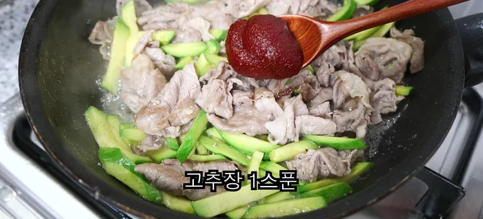 Add gochujang, oyster sauce, sugar, red pepper powder, and minced garlic. Stir-fry until pork is golden brown.