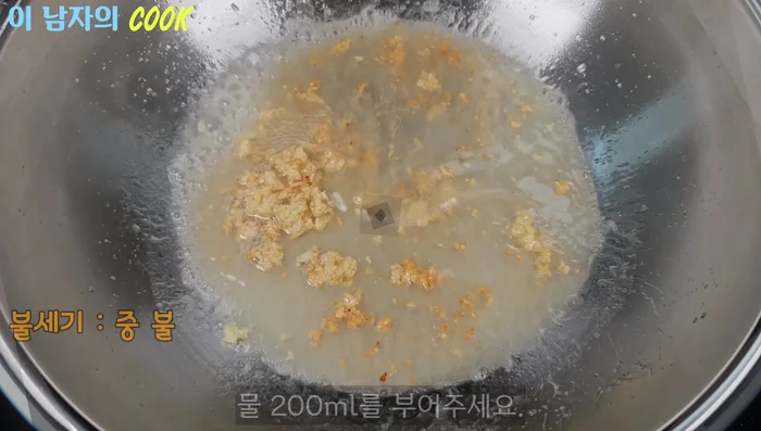 Pour one cup (200ml) of water into the wok. Add five spoons of brewing soy sauce, three spoons of mirin, and two spoons of rice syrup.