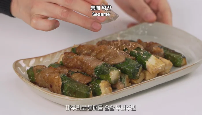 Turn off the heat, plate the rolls, and garnish with sesame seeds.