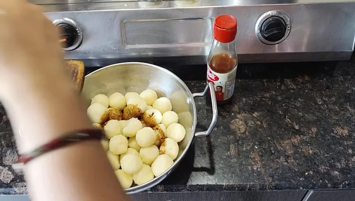Add half a lid of soy sauce, chili sauce (to taste), and white oil to the potato balls. Mix well.