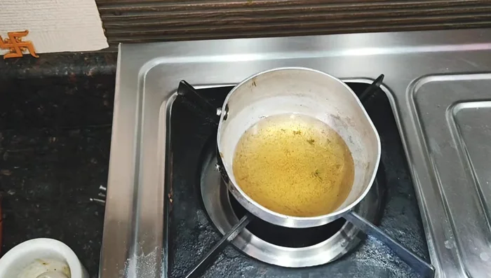 Heat oil in a pan and sauté 4-5 chopped garlic cloves and chili flakes until lightly browned.