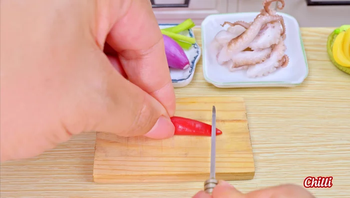 Start cooking the dish in the miniature kitchen.