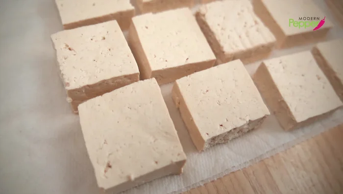 Salt the tofu: Lightly salt one side of each tofu block.