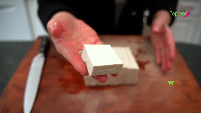 Press the tofu: Place tofu blocks between paper towels, top with a plate, and let it sit for 10 minutes to remove excess water.