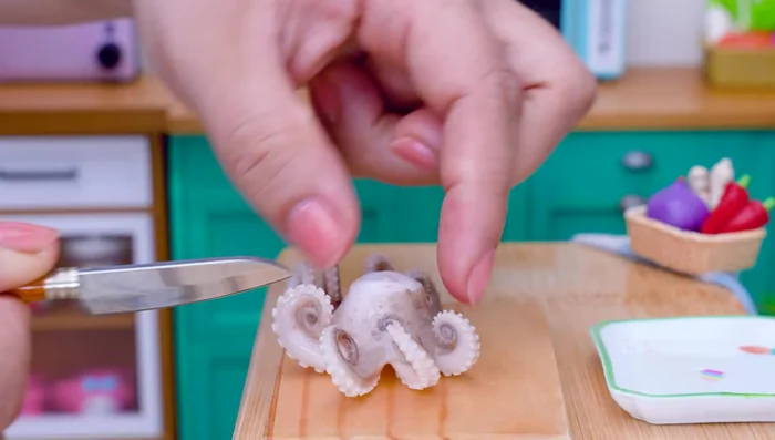 Cut the octopus tentacles into small pieces. Add gochujang, black pepper, chili powder, sugar, soy sauce, chili garlic, and lemon; mix well.