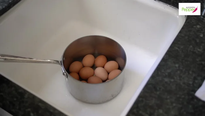 Place eggs in a pot, cover with water (1 inch above eggs), add salt and vinegar. Gently swirl for 30 seconds.