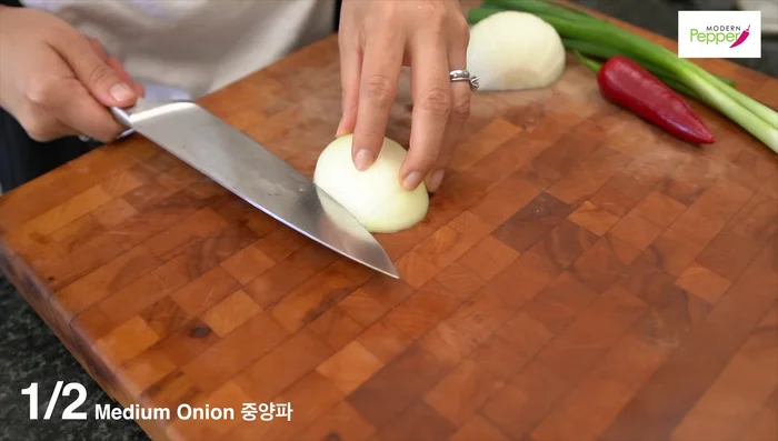 Prepare vegetables: Slice onion, chop scallions, and thinly slice red pepper (remove seeds).