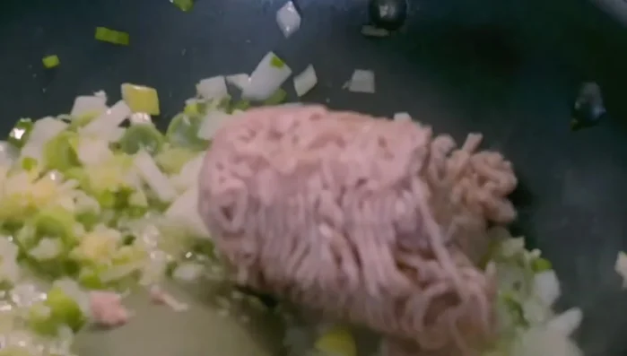Add minced pork and cook until browned, do not stir too much.