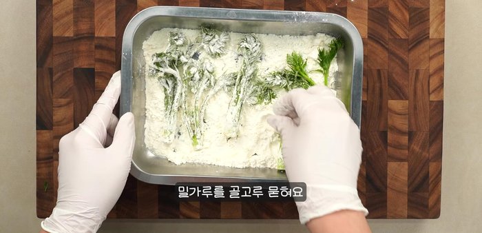 Dip the tree fern fiddleheads into the batter, ensuring they are fully coated.