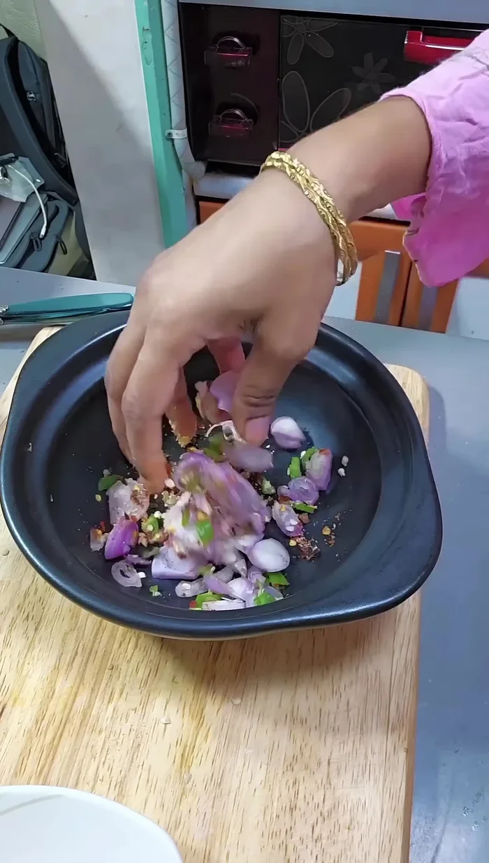 Mix the chopped raw chilies with the chopped onion. Mix well for about 30 seconds until softened.