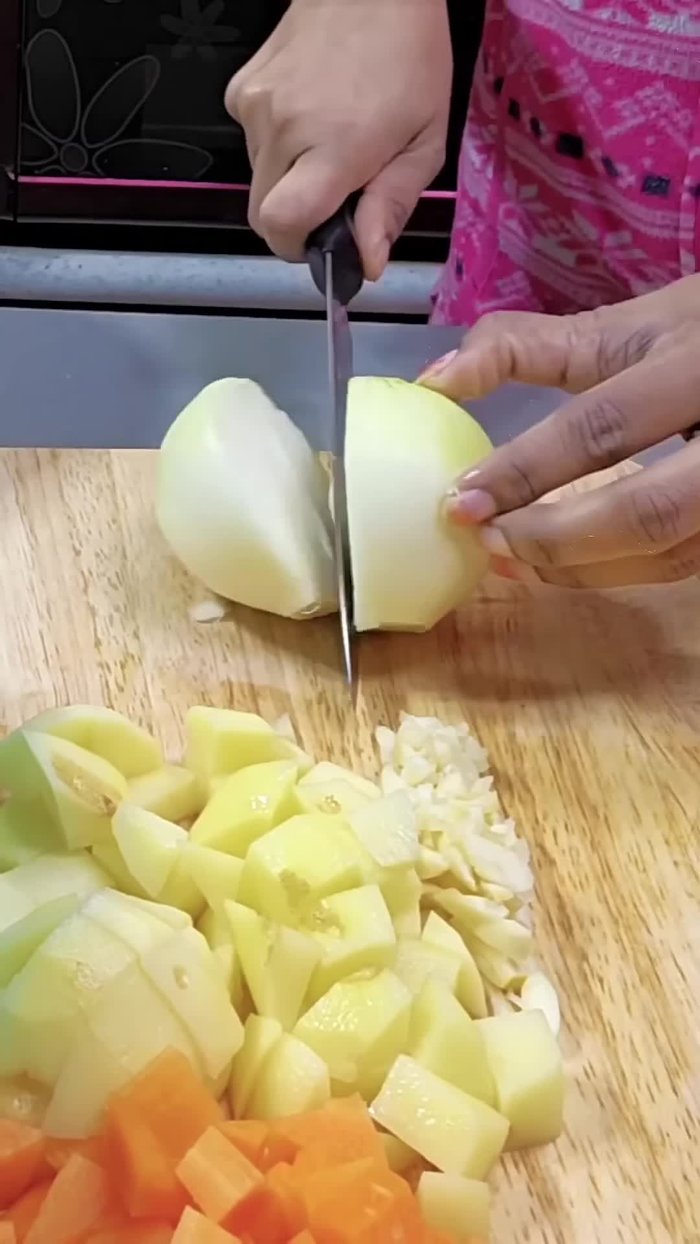 Chop the Korean onions. (Note: The speaker dislikes the sweetness of Korean onions but uses them in this recipe.)