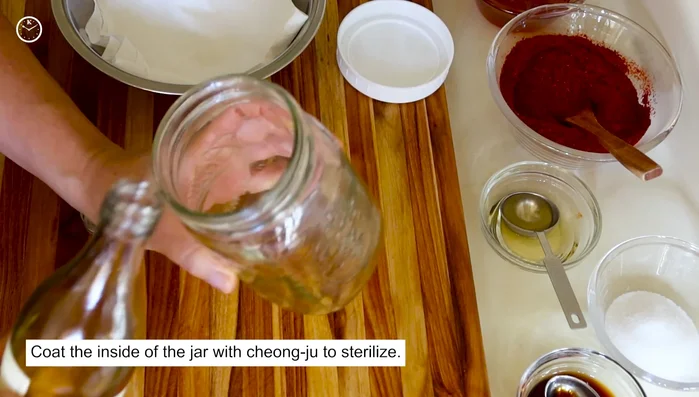 Sterilize a jar. Once the gochujang mixture has cooled, add the salt, rice syrup, and fermented soybean powder.