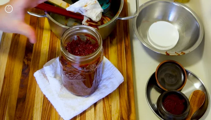 Ferment the gochujang at room temperature, uncovered, for 4 weeks. Use cheesecloth or a mesh strainer to cover the jar, allowing air circulation.