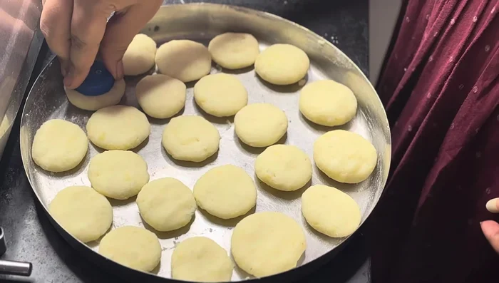 Using a bottle or lid, gently flatten each patty.