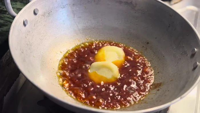 Add the cooked potato patties to the sauce. (Optional: Add ginger and garlic powder or paste beforehand).