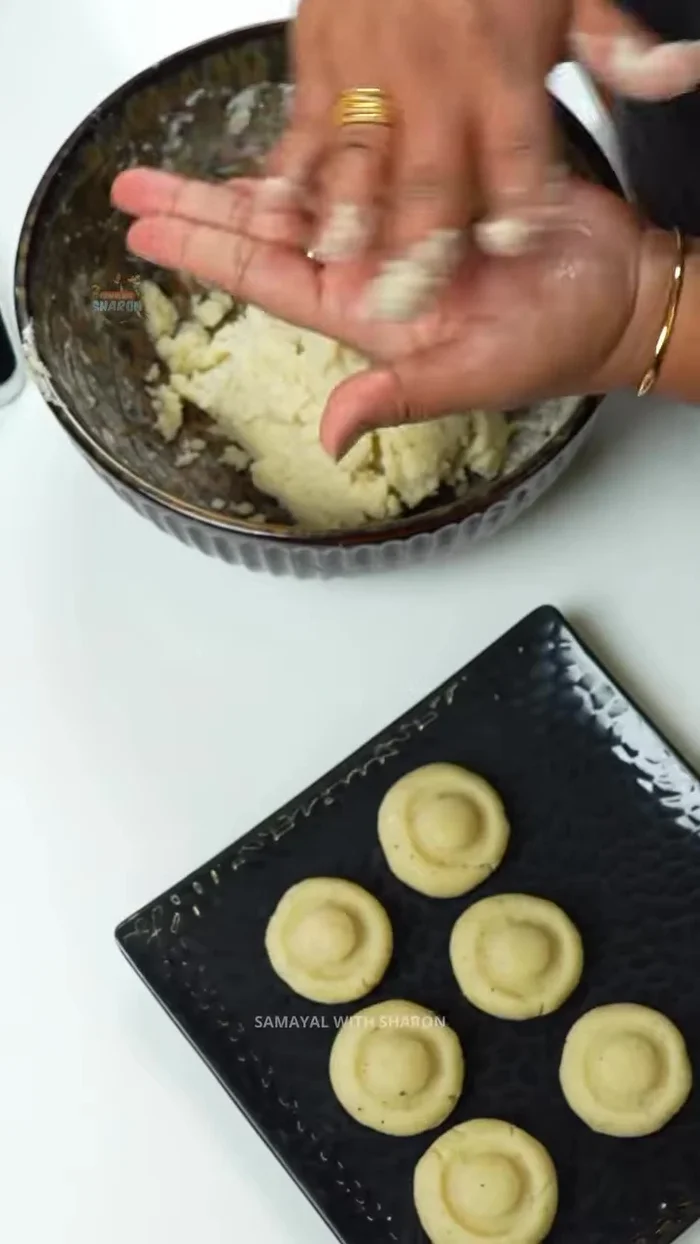 Lightly oil your hands, roll small portions of the dough into mushroom shapes, and flatten them using a water bottle.