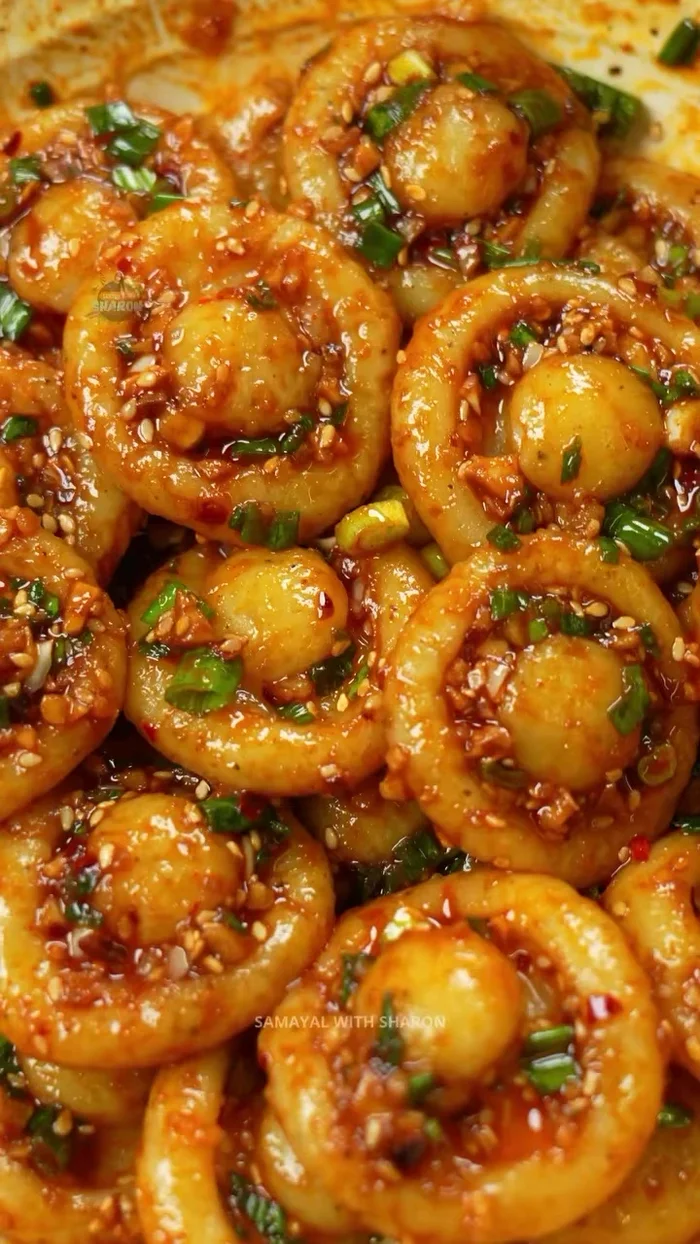 Add the cooled potato mushrooms to the sauce and mix well. Garnish with extra spring onions and sesame seeds.