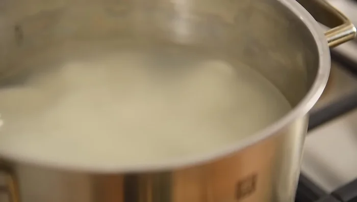 Add a couple of splashes of the cooking water from the rice cakes to the pan, then drain the water from the rice cakes and add them to the pan.