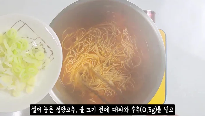 Transfer the cooked noodles and vegetables to a bowl.