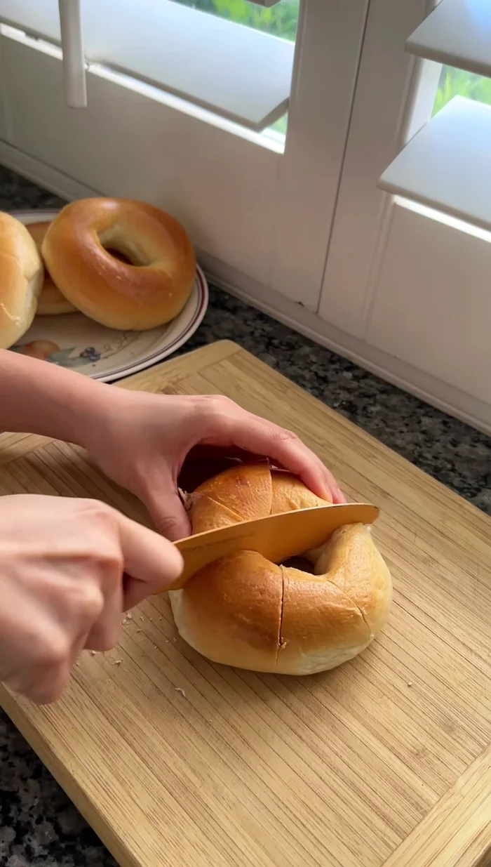 Make six slits into each bagel by cutting it three times; slightly turn an inch between each cut.